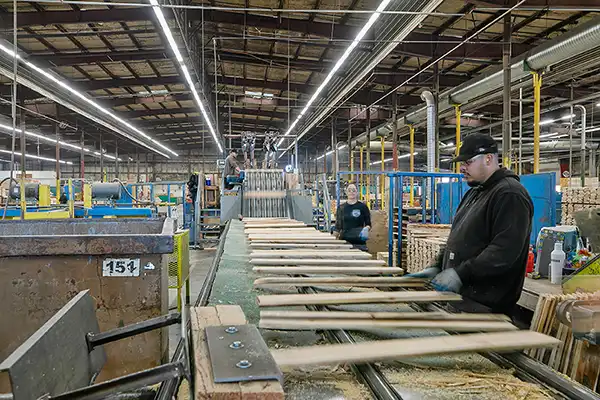 assembly worker constructing pallets in a large warehouse